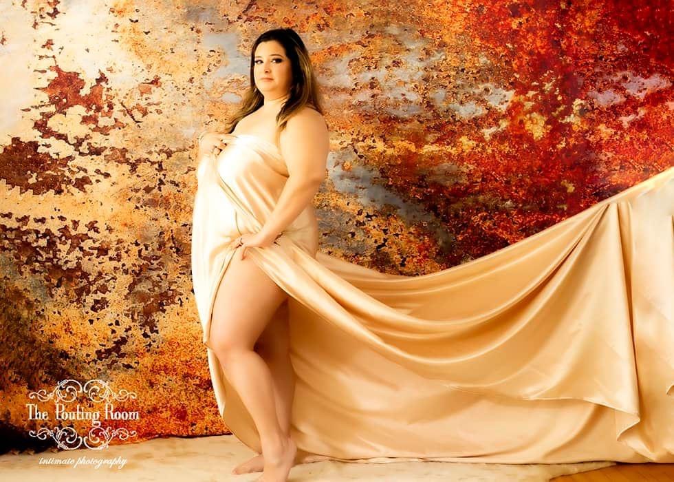 Girl wearing a champagne colored sheet for a photo shoot